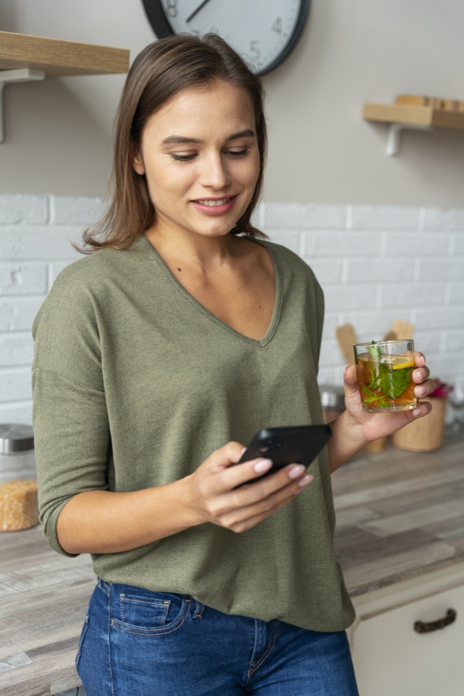 front-view-woman-holding-smartphone